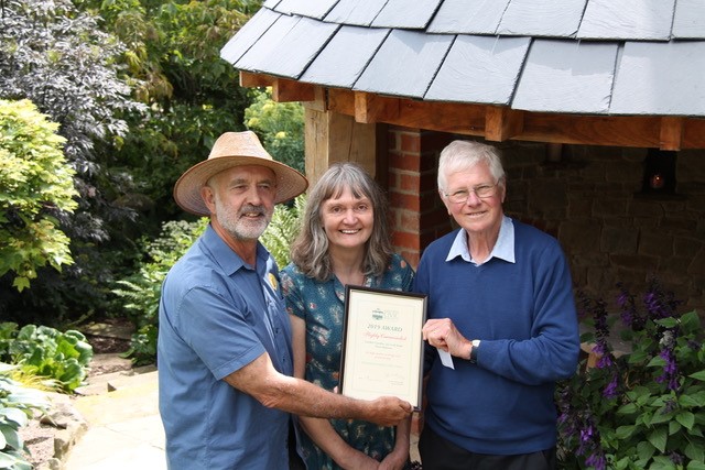 Andy and Cathy Adams receiving a Malvern Civic Award Highly Commended certificate for their charming garden gazebo at 24 Croft Bank, West Malvern.